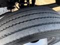A close-up of a tire from a 2010 Ford F-450 showing tread patterns and wear on the surface