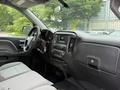 Interior view of a 2016 GMC Sierra 1500 showing the dashboard steering wheel and center console with touchscreen display and controls