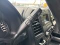 Close-up of the gear shift lever and control panel of a 2020 Ford F-150 with buttons for drive mode and volume adjustment