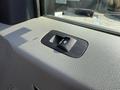 A close-up of the window control switch on the interior door panel of a 2022 Ford F600