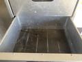Open drawer of a 2008 Wells Industries Inc EW1422 empty with a flat bottom and metal sides showing screw holes along the edges