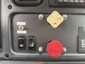 Dashboard controls of a 2005 Freightliner M2 106 including switches for outside spin and MBR heat along with a red button and a yellow release lever
