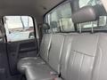Interior of a 2006 Dodge Ram 2500 featuring leather back seats with seatbelts and headrests