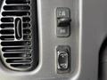 Controls and knobs on the dashboard of a 2013 Freightliner 114SD including air vent and switch for adjusting settings