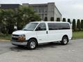 A white 2004 Chevrolet Express van with silver wheels and tinted windows positioned at a slight angle