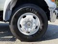 A close-up of a white wheel on a 2008 Ford F-750 with a black tire featuring the brand name AriSun and visible lug nuts