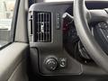 Interior dashboard controls of a 2019 Chevrolet Express featuring air conditioning vents a knob for headlights and various switches and buttons