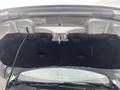 The image shows the underside of the hood of a 2018 Ford Focus with a black sound deadening pad and a protective label attached