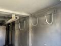 A close-up view of several metal hooks installed inside a compartment of a 2011 International 7500 truck