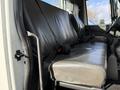 A gray vinyl bench seat of a 2010 International 4300 with seat belts attached