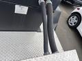 Two black rubber hoses connected to a metal fitting on a gray surface with a visible label indicating specifications of a 2005 Katolight SED60FPJ4