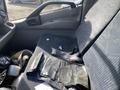 A single driver's seat of a 2019 Hino 195 with a seatbelt visible and various items like plastic bags and pieces of paper scattered on the seat