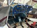 Cockpit of a 1986 Sorrell Hiperbipe SNS-7 Amateur-Built Aircraft featuring various instruments controls and seats with red and gray upholstery