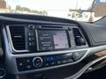 A 2018 Toyota Highlander dashboard displaying a digital touchscreen with navigation and audio controls