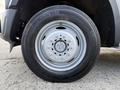A close-up view of a silver alloy wheel with a circular hub and multiple lug nut holes mounted on a black tire designed for a 2008 Ford F-450