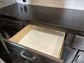 An open drawer with a wooden interior inside a 2021 Jayco Jay Flight kitchen area