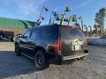 A black 2007 Cadillac Escalade parked with a sleek design large wheels and distinctive rear lights