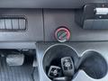 Close-up of the dashboard area in a 2019 Mercedes-Benz Sprinter showing climate control knobs and cup holder with Mercedes keys