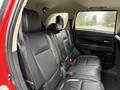 The interior view of a 2016 Mitsubishi Outlander showing the black leather rear seats with seat belts
