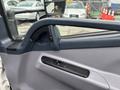 Interior door handle and armrest of a 2015 Mitsubishi Fuso FE160 truck door showing a blue color scheme and simple design