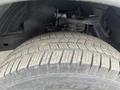 Close-up of a 2004 Toyota Tacoma tire showing detailed tread patterns and part of the suspension system
