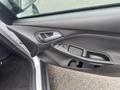 Interior door panel of a 2018 Ford Focus featuring control buttons for windows and door locks