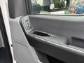 Interior door handle and armrest of a 2023 Ford F-450 Super Duty with controls for windows and locks