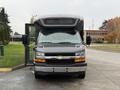 A 2020 Chevrolet Express with a raised roof and open door facing forward
