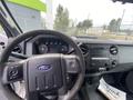 Interior view of a 2014 Ford F-350 Super Duty featuring a steering wheel dashboard and center console with radio controls and instrumentation
