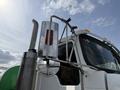 A 1996 Kenworth T800 semi-truck with a chrome exhaust and side mirror featuring a red reflector