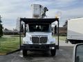 A 2012 International DuraStar 4300 truck with a mounted equipment platform and a large bucket on top for elevation tasks