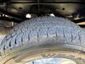 Close-up of a rugged tire from a 2022 Ford F-350 SD showcasing deep tread patterns designed for off-road traction