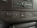 Close-up of the control panel inside a 2023 GMC Savana featuring various buttons and knobs for audio, climate control, and vehicle settings