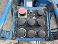 Control panel of a 2016 Genie TZ-34/20 with various buttons and switches for operating the lift