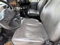 A gray leather driver's seat of a 2016 International 7600 with control buttons and equipment visible on the dashboard