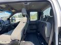 Interior of a 2017 Ford F-250 SD showing front and back seats with fabric upholstery and a console in the center