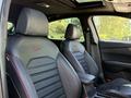 The interior of a 2024 Kia Forte5 featuring sporty black leather seats with red stitching and a sleek design