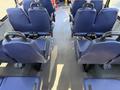 Interior view of a 2020 Chevrolet Express showing rows of blue fabric seats arranged in two columns facing forward