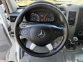 Steering wheel of a 2016 Mercedes-Benz Sprinter with controls and the Mercedes logo visible on the center hub
