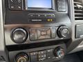 Dashboard controls of a 2020 Ford F-550 featuring buttons for volume tuning and climate control settings