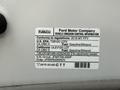 A 2018 Ford F-150 with a vehicle emission control information label detailing compliance and fuel specifications