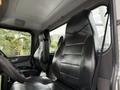 Interior of a 2016 Peterbilt 348 featuring a black leather driver's seat with distinct stitching and an ergonomic design