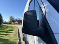 A 2021 Mercedes-Benz Sprinter 2500 van with a focus on the side mirror in the foreground