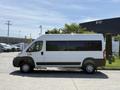 A white 2021 RAM Promaster van parked on a concrete surface with large windows and a sleek design