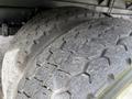 Close-up of two worn tires from a 2008 International CityStar showing tread patterns and dirt on the surface