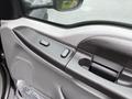 Interior door panel of a 2006 Ford F-450 SD featuring control buttons for windows and locks