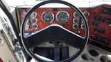 Close-up of the steering wheel dashboard of a 2003 International 5600i showing various gauges and controls