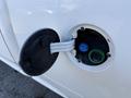 Close-up of the fuel filler cap on a 2023 RAM 3500 revealing a blue fuel nozzle and green filler neck indicating diesel fuel type