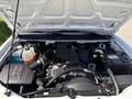 Engine compartment of a 2011 Chevrolet Colorado with visible components like the air intake, battery, and coolant reservoir