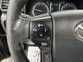 Close-up of the steering wheel controls of a 2021 Toyota 4Runner showing buttons for audio adjustments and driving modes